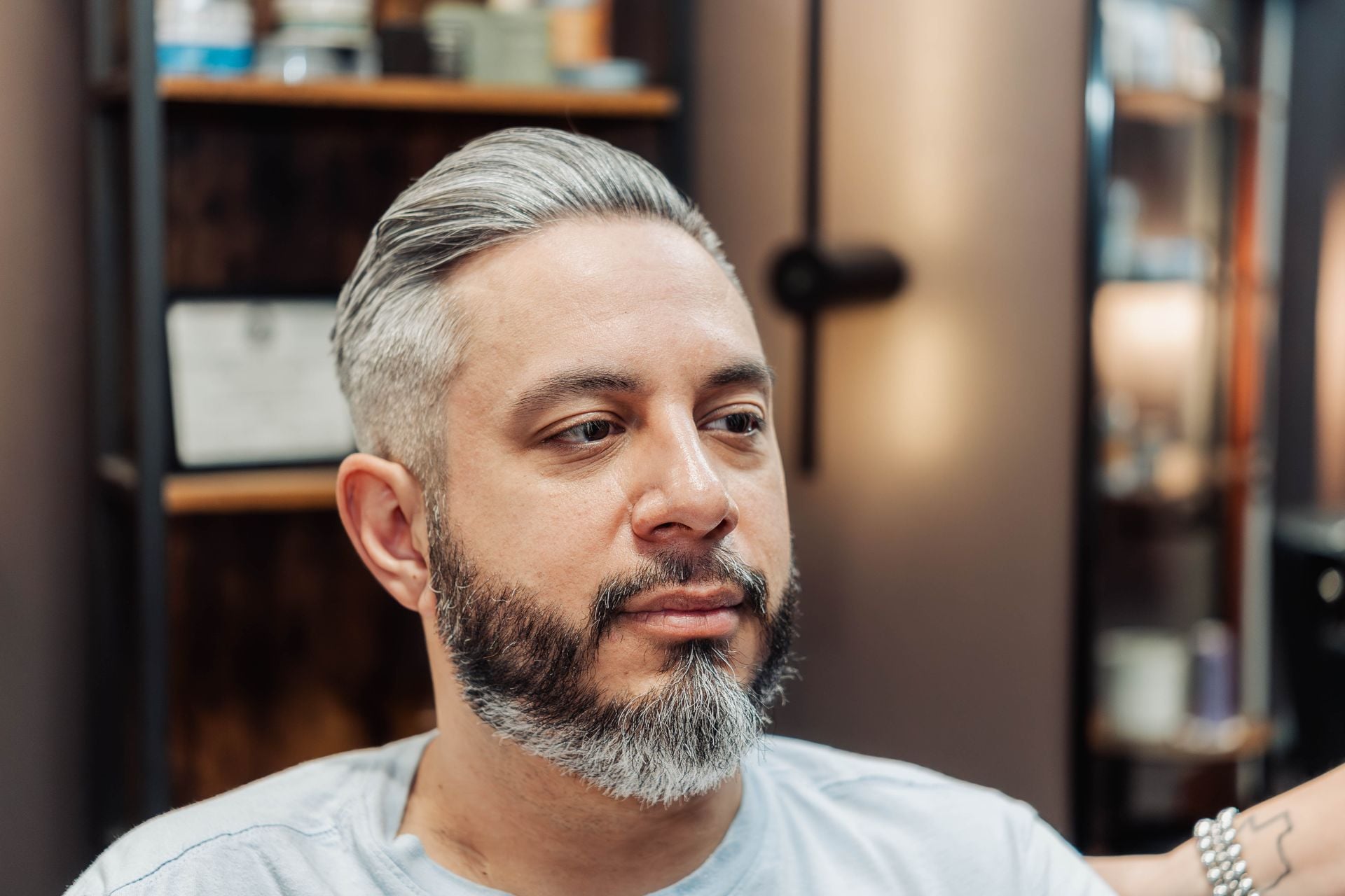 Client showing off a finished pompadour haircut at The Speakeasy Barber