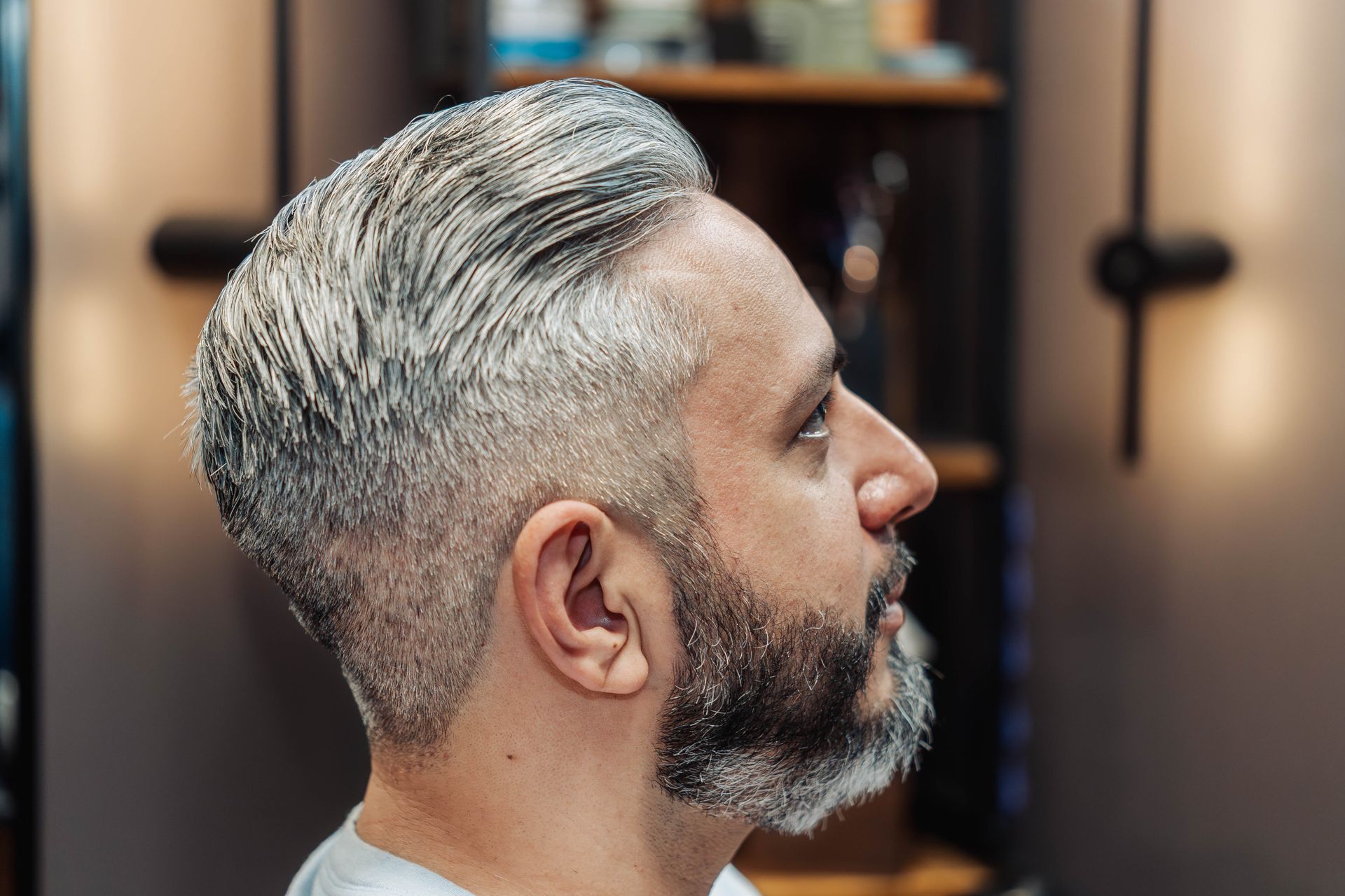 Smiling client with a finished haircut at The Speakeasy Barber in Austin, TX