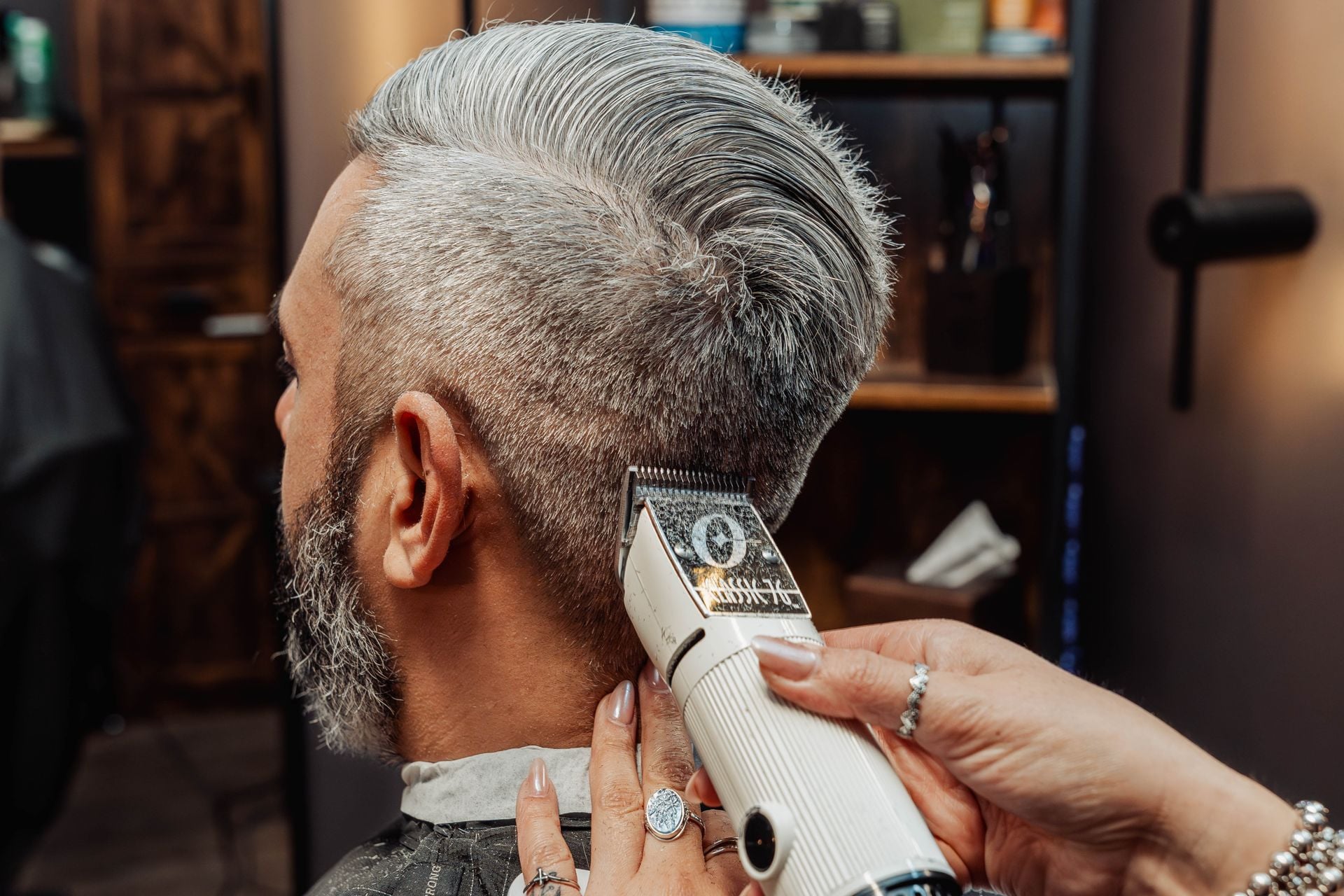 Scissor-over-comb work during a men's haircut at The Speakeasy Barber