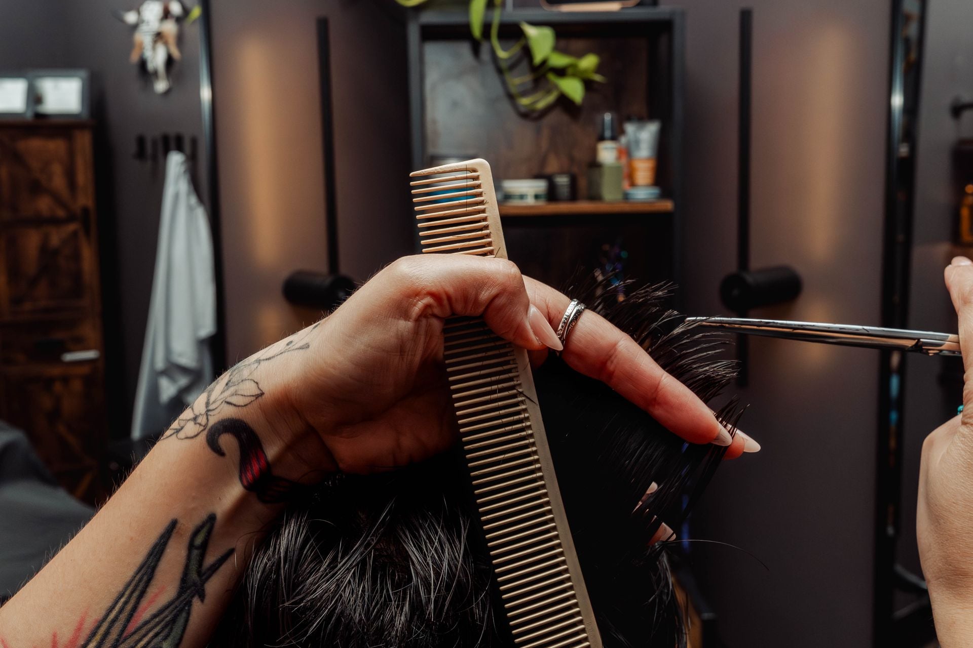Profile of a slicked-back men's haircut in progress at The Speakeasy Barber
